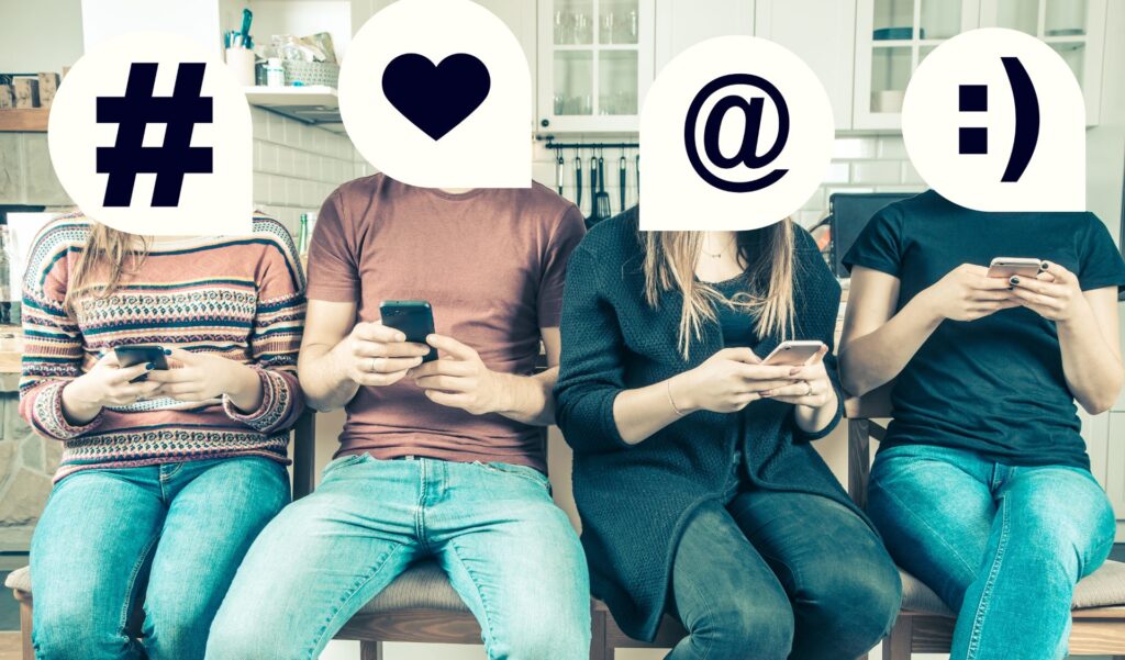 Quatre jeunes assis côte à côte sur leur téléphone, le visage remplacé par des symboles de réseaux sociaux